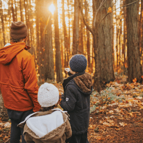 family in autumnal forest