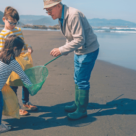 family on beach litter picking